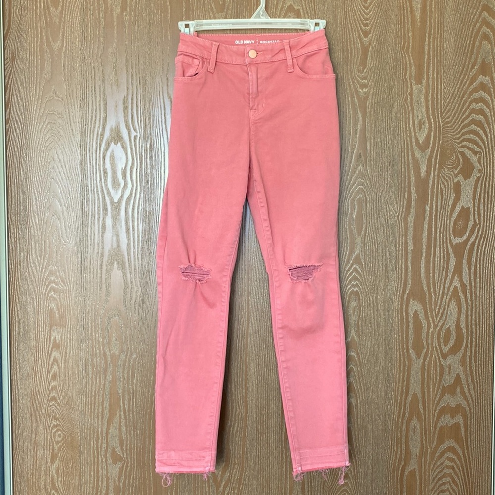 Light pink/coral straight-legged jeans with knee-holes and distressed bottoms
